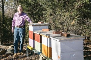 Star Photo/Brandon Hicks Joe Shultz is pictured beside his hives.