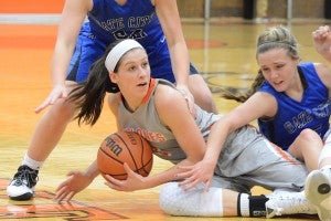 Kayla Marosites scrambles to get control of the basketball while being hounded by two Lady Blue Devils.