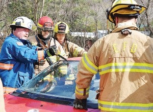 Star Photo/Rebekah Price  Rescue Squad Captain Ed McNeil (left) demonstrates how to safely remove a windshield.
