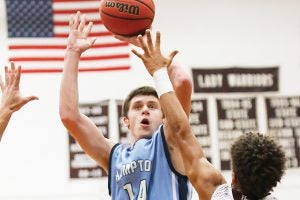 Star Photo/Bryce Phillips  Hampton's Wyatt Lyons goes up for a jumper while Happy Valley's Brayden Sams puts a hand in his face.